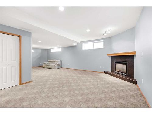 21 Cottonwood Close Sw, Medicine Hat, AB - Indoor Photo Showing Other Room With Fireplace