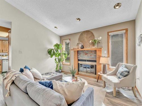 5 Ross View Bay Se, Medicine Hat, AB - Indoor Photo Showing Living Room With Fireplace