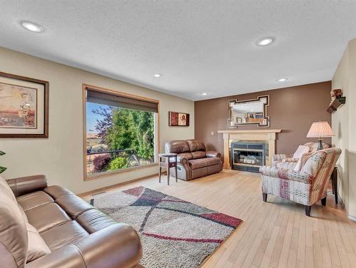 83 Taylor Boulevard Se, Medicine Hat, AB - Indoor Photo Showing Living Room With Fireplace