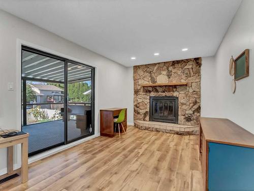 24 Hayward Close Ne, Medicine Hat, AB - Indoor Photo Showing Living Room With Fireplace