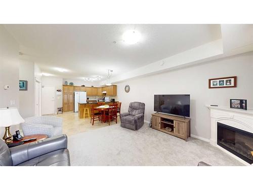 207-2800 13 Avenue Se, Medicine Hat, AB - Indoor Photo Showing Living Room With Fireplace