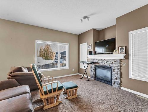 53 Hamptons Way Se, Medicine Hat, AB - Indoor Photo Showing Living Room With Fireplace