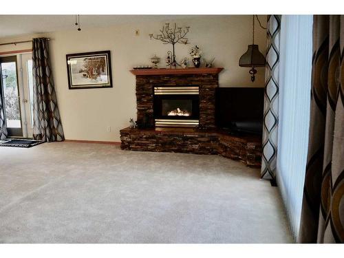 8501 Highway 570, Oyen, AB - Indoor Photo Showing Living Room With Fireplace