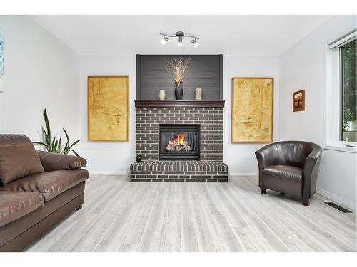 107 Sunset Road Sw, Medicine Hat, AB - Indoor Photo Showing Living Room With Fireplace