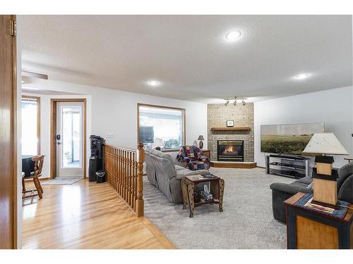 23 Taylor Close Se, Medicine Hat, AB - Indoor Photo Showing Living Room With Fireplace