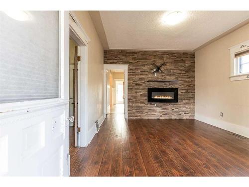 825 8 Street Se, Medicine Hat, AB - Indoor Photo Showing Living Room With Fireplace