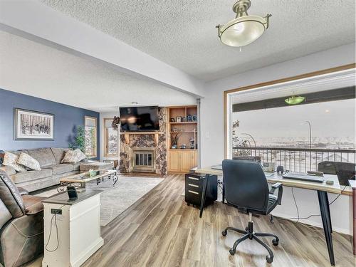 15-1165 16 Street Ne, Medicine Hat, AB - Indoor Photo Showing Living Room With Fireplace