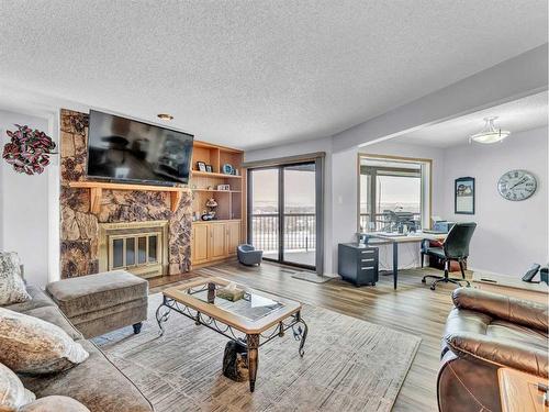 15-1165 16 Street Ne, Medicine Hat, AB - Indoor Photo Showing Living Room With Fireplace