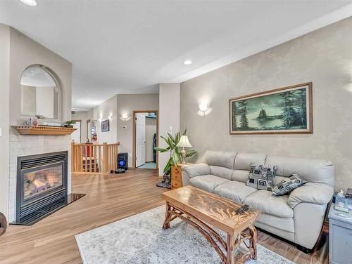 15 Turner Green Se, Medicine Hat, AB - Indoor Photo Showing Living Room With Fireplace