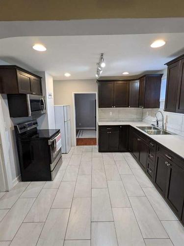 111 2 Street Ne, Medicine Hat, AB - Indoor Photo Showing Kitchen With Double Sink