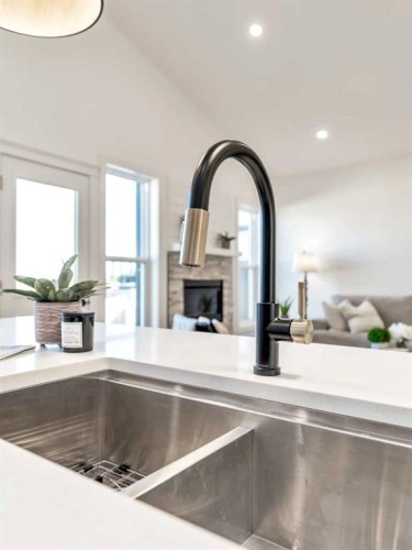 32 Somerside Way Se, Medicine Hat, AB - Indoor Photo Showing Kitchen With Fireplace With Double Sink