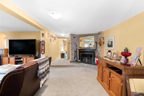 428 6 Street, Suffield, AB - Indoor Photo Showing Living Room With Fireplace