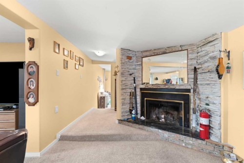 428 6 Street, Suffield, AB - Indoor Photo Showing Living Room With Fireplace
