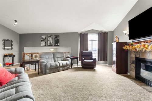 404 Jesmond Place Sw, Redcliff, AB - Indoor Photo Showing Living Room With Fireplace