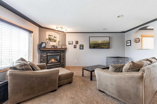 484 Stark Way Se, Medicine Hat, AB - Indoor Photo Showing Living Room With Fireplace