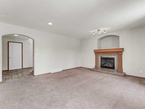 18 Vista Close Se, Medicine Hat, AB - Indoor Photo Showing Living Room With Fireplace