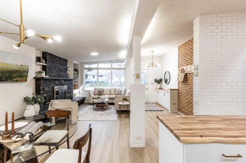 150 11 Street Ne, Medicine Hat, AB - Indoor Photo Showing Other Room With Fireplace