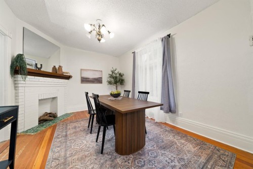 387 5 Street Se, Medicine Hat, AB - Indoor Photo Showing Dining Room With Fireplace