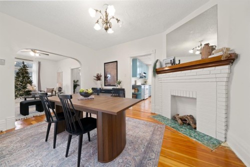 387 5 Street Se, Medicine Hat, AB - Indoor Photo Showing Dining Room With Fireplace