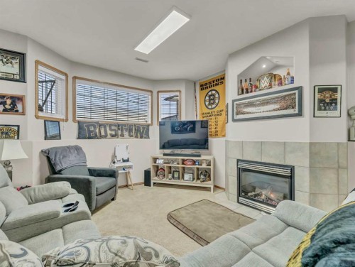 9 Riverview Green Se, Redcliff, AB - Indoor Photo Showing Living Room With Fireplace