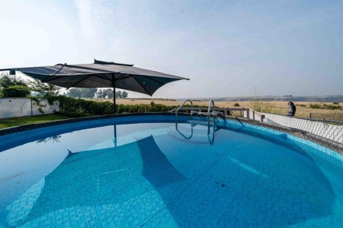 110 Redcliff Way Sw, Redcliff, AB - Outdoor With In Ground Pool With Backyard