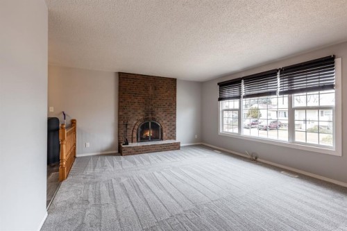 1919 9 Avenue Ne, Medicine Hat, AB - Indoor Photo Showing Living Room With Fireplace