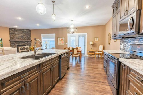 208 Westview Crescent West, Bow Island, AB - Indoor Photo Showing Kitchen With Fireplace With Double Sink