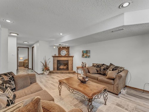 32 Sunrise Court Sw, Medicine Hat, AB - Indoor Photo Showing Living Room With Fireplace