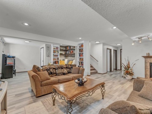 32 Sunrise Court Sw, Medicine Hat, AB - Indoor Photo Showing Living Room With Fireplace