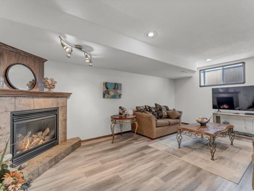32 Sunrise Court Sw, Medicine Hat, AB - Indoor Photo Showing Living Room With Fireplace