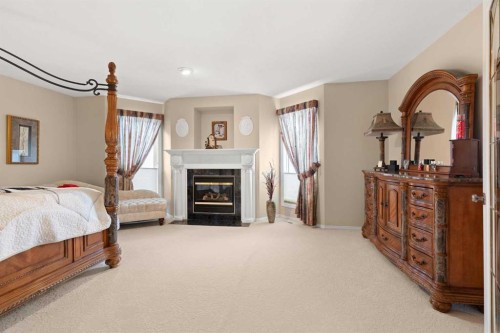 22 Turner Crescent Se, Medicine Hat, AB - Indoor Photo Showing Bedroom With Fireplace