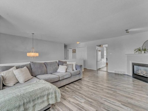 416 Redcliff Way Se, Redcliff, AB - Indoor Photo Showing Living Room With Fireplace