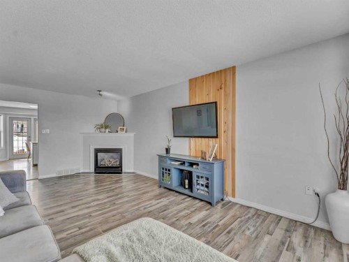 416 Redcliff Way Se, Redcliff, AB - Indoor Photo Showing Living Room With Fireplace