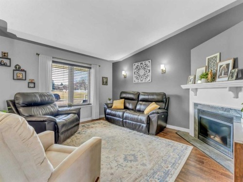 32 Spruce Close Se, Medicine Hat, AB - Indoor Photo Showing Living Room With Fireplace