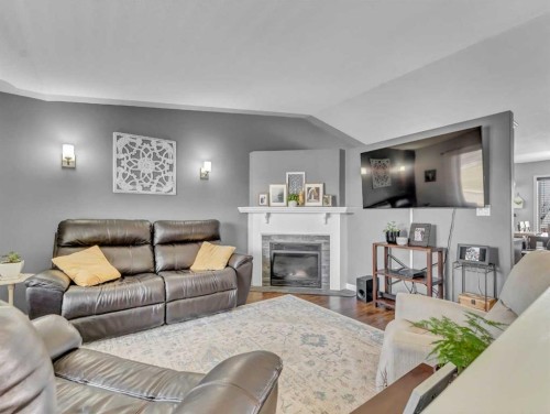 32 Spruce Close Se, Medicine Hat, AB - Indoor Photo Showing Living Room With Fireplace