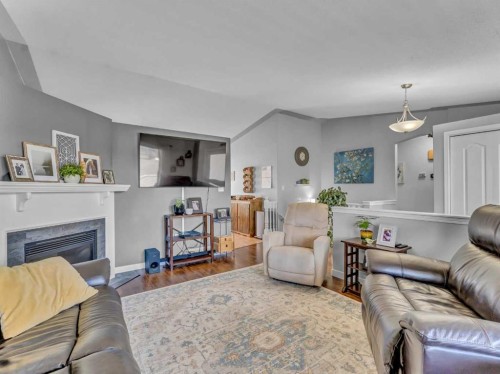 32 Spruce Close Se, Medicine Hat, AB - Indoor Photo Showing Living Room With Fireplace