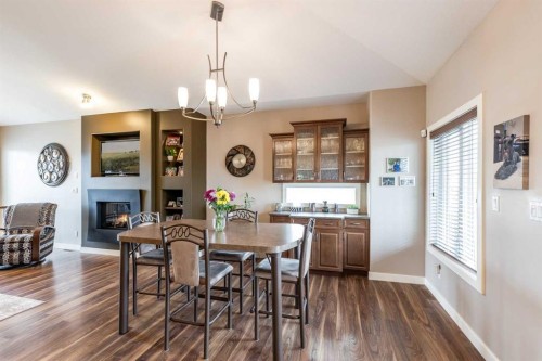 207 Hamptons Way Se, Medicine Hat, AB - Indoor Photo Showing Dining Room With Fireplace