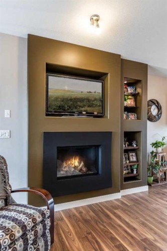 207 Hamptons Way Se, Medicine Hat, AB - Indoor Photo Showing Living Room With Fireplace