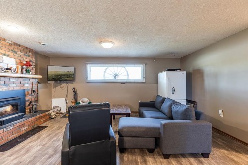 9 Rossmere Avenue Se, Medicine Hat, AB - Indoor Photo Showing Living Room With Fireplace