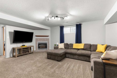 453 Stark Way Se, Medicine Hat, AB - Indoor Photo Showing Living Room With Fireplace