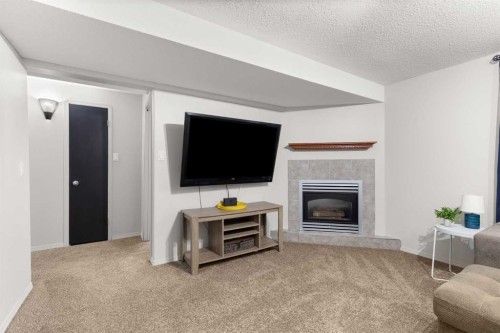453 Stark Way Se, Medicine Hat, AB - Indoor Photo Showing Living Room With Fireplace