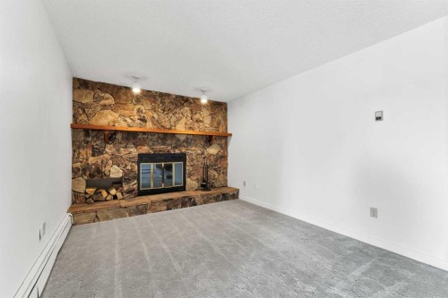 211-1051 3 Street Nw, Medicine Hat, AB - Indoor Photo Showing Living Room With Fireplace