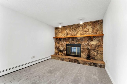 211-1051 3 Street Nw, Medicine Hat, AB - Indoor Photo Showing Living Room With Fireplace