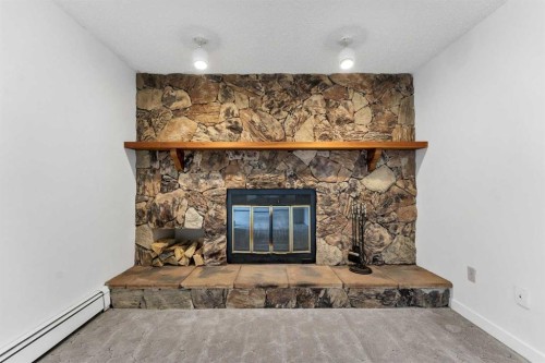 211-1051 3 Street Nw, Medicine Hat, AB - Indoor Photo Showing Living Room With Fireplace