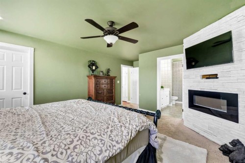7312 Township Road 124, Rural Cypress County, AB - Indoor Photo Showing Bedroom With Fireplace
