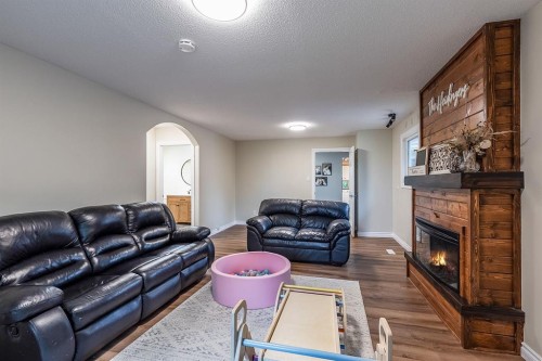 22 5 Avenue, Seven Persons, AB - Indoor Photo Showing Living Room With Fireplace