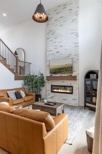 21 Hamptons Gate Se, Medicine Hat, AB - Indoor Photo Showing Living Room With Fireplace