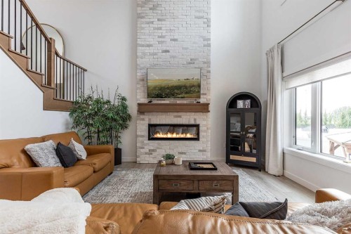 21 Hamptons Gate Se, Medicine Hat, AB - Indoor Photo Showing Living Room With Fireplace