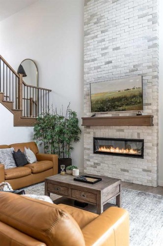 21 Hamptons Gate Se, Medicine Hat, AB - Indoor Photo Showing Living Room With Fireplace
