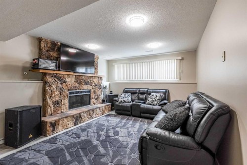 73 Cooper Road Se, Medicine Hat, AB - Indoor Photo Showing Living Room With Fireplace